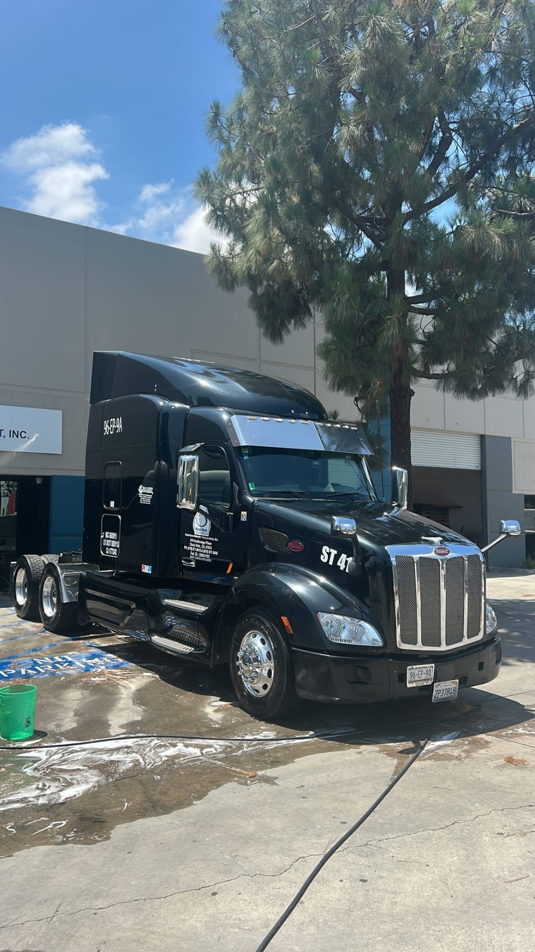 Black Peterbilt sleeper truck after a wash