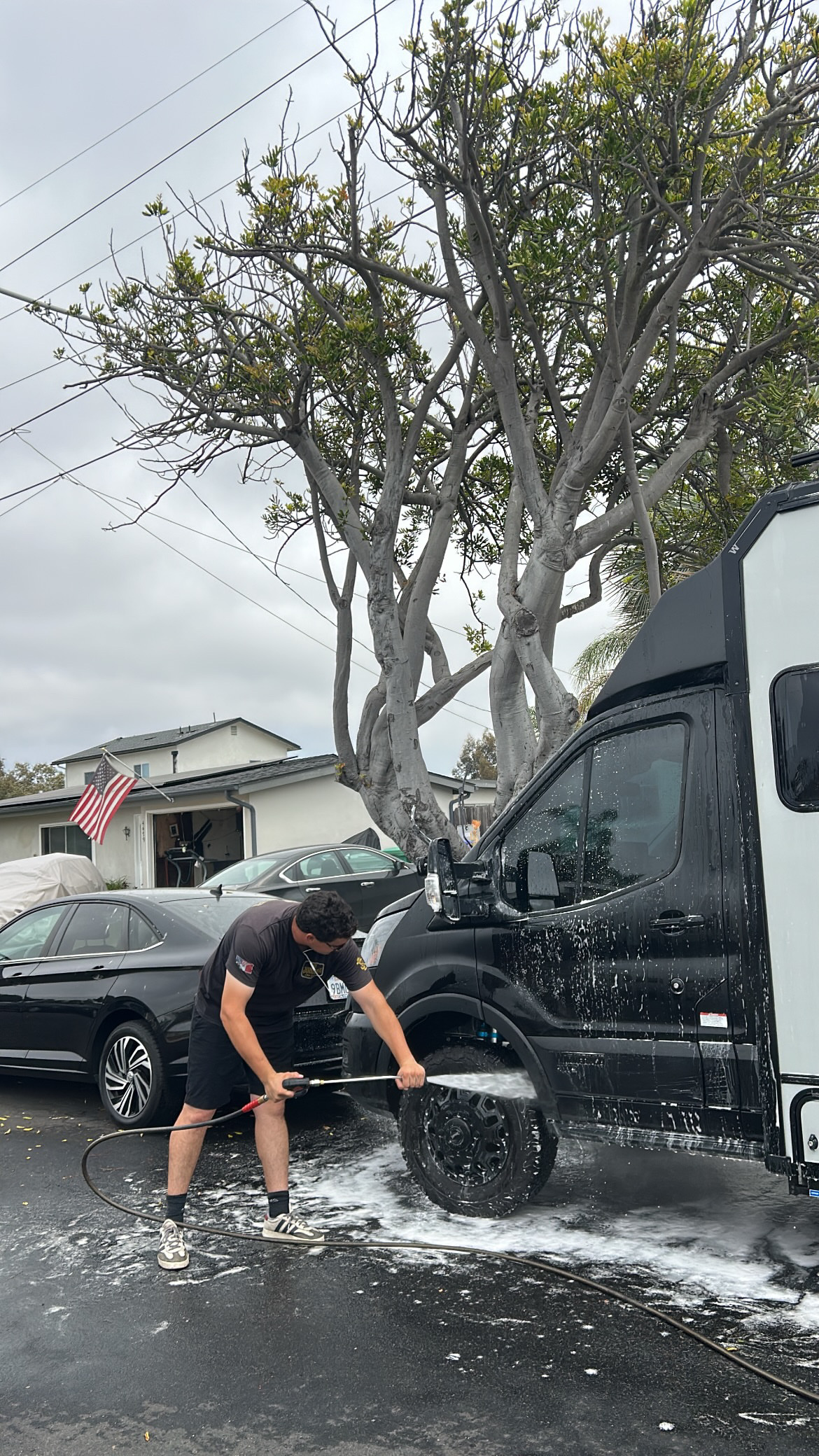 Technician washing the wheels of a commercial van