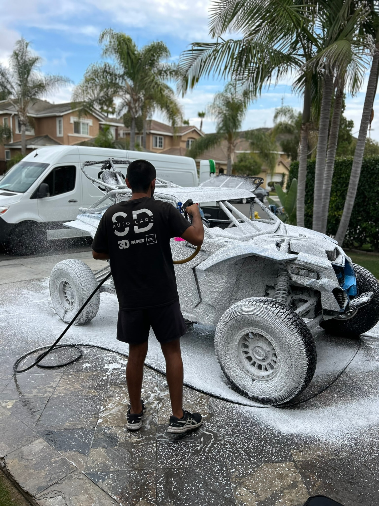 San Diego Auto Care technician foam washing a Can-Am X3